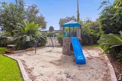 a playground with a blue slide in a yard at 18-Universal and Heart of International Dr in Orlando