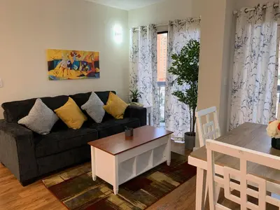 a living room with a couch and a table at 18-Universal and Heart of International Dr in Orlando