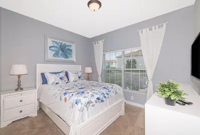 a white bedroom with a bed and a window at 3087LL Townhouse 5 Bedrooms & 4 Bathrooms Pool in Kissimmee