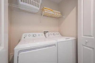a white washer and dryer in a laundry room at 3087LL Townhouse 5 Bedrooms & 4 Bathrooms Pool in Kissimmee