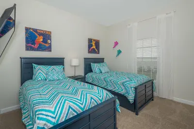a bedroom with two beds and a window at 3087LL Townhouse 5 Bedrooms & 4 Bathrooms Pool in Kissimmee