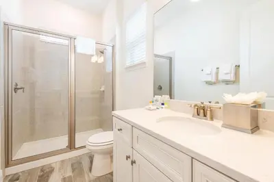 a bathroom with a shower and a toilet and a sink at Sandy Shores Cottage Near Disney With Margaritaville Resort & Island H20 Waterpark Access - 2962Sr in Orlando