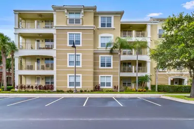a large apartment building with a parking lot at Vista Cay in Orlando