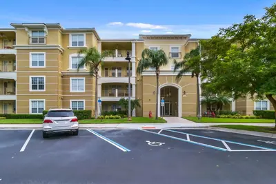 a car parked in a parking lot in front of a building at Vista Cay in Orlando