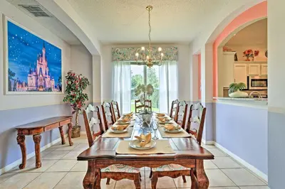 a dining room with a table and chairs at 14 Mi to Disney Parks Spacious Kissimmee Home in Kissimmee