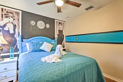 a bedroom with a blue bed with a doll on it at 14 Mi to Disney Parks Spacious Kissimmee Home in Kissimmee