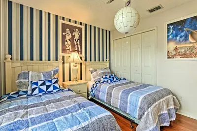 two beds in a bedroom with blue and white at 14 Mi to Disney Parks Spacious Kissimmee Home in Kissimmee