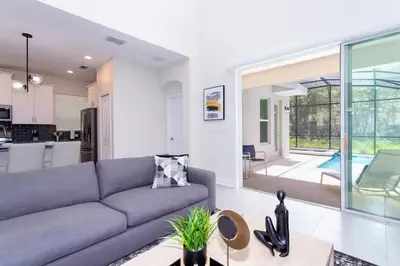 a living room with a couch and a table at Stunning 5 Bd w/ Pool Close to Disney @ Storey Lake 2767 in Kissimmee