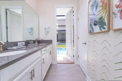 a bathroom with a sink and a mirror at Stunning 5 Bd w/ Pool Close to Disney @ Storey Lake 2767 in Kissimmee
