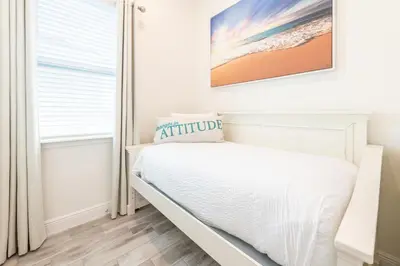 a white bedroom with a bed and a window at Blue Shores Cottage Near Disney With Margaritaville Resort & Island H2O Access - 8079Kd in Orlando