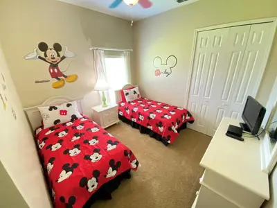 a bedroom with two beds and a mickey mouse bedroom at Mickeys Corner - Fantastic 5BR with Large Private Garden Pool Hot Tub Game Room Gas BBQ 2 Miles to Disney in Orlando