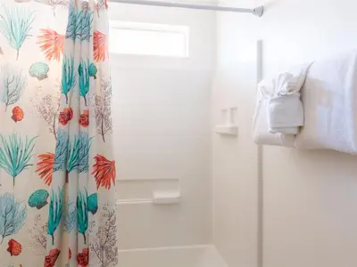 a shower curtain in a bathroom with a shower backdoor at 4 Bed And 3 Bath In Perfect Location With Pool By Florida Dream Home in Kissimmee