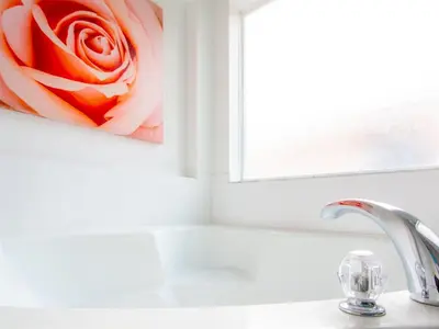 a bathroom sink with a red rose painting on the wall at 4 Bed And 3 Bath In Perfect Location With Pool By Florida Dream Home in Kissimmee