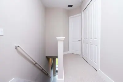 a hallway with white walls and a white door at Gorgeous 4 Bedroom Family Friendly Close to Disney 7573 in Orlando