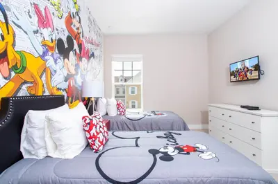 a bedroom with two beds and a painting on the wall at Gorgeous 4 Bedroom Family Friendly Close to Disney 7573 in Orlando