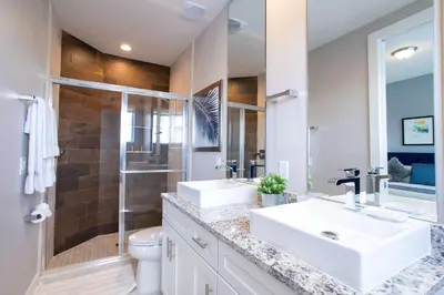 a bathroom with two sinks and a shower at Gorgeous 4 Bedroom Family Friendly Close to Disney 7573 in Orlando