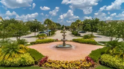 a fountain in the middle of a park at Villas at Seven Dwarfs - Close to Disney in Kissimmee