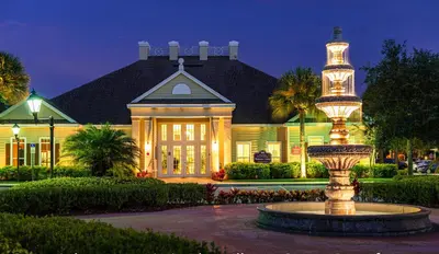 a large house with a fountain in front of a building at Villas at Seven Dwarfs - Close to Disney in Kissimmee