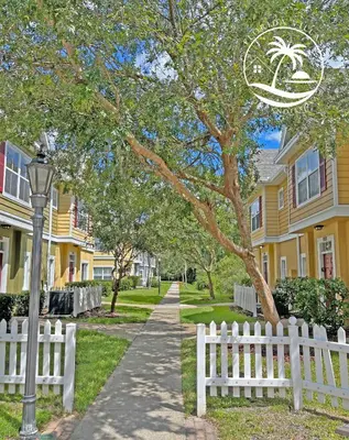 a white fence in front of a row of houses at Villas at Seven Dwarfs - Close to Disney in Kissimmee