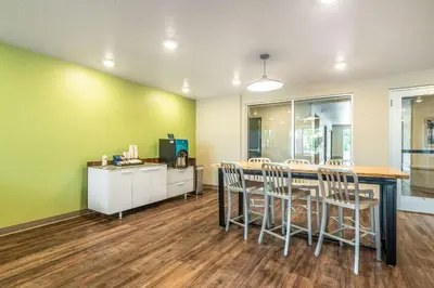a dining room with a table and chairs at WoodSpring Suites Sanford North I-4 Orlando Area in Sanford