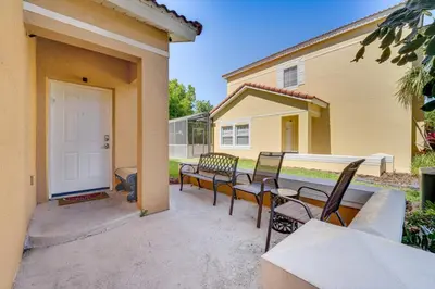 a group of chairs sitting on a patio at 8 Mi to Disney Villa with Screened Pool and Lanai in Kissimmee