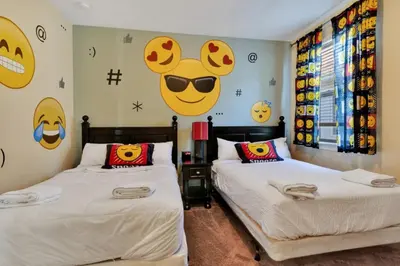 two beds in a room with faces on the wall at 491 Lasso dr in Orlando