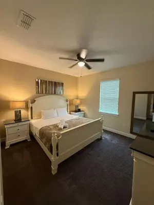 a bedroom with a bed with a ceiling fan at 491 Lasso dr in Orlando