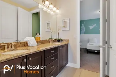 a bathroom with a sink and a large mirror at 7617 Brookhurst lane in Orlando