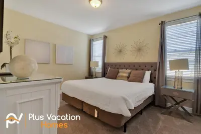 a bedroom with a bed and a desk and a window at 7617 Brookhurst lane in Orlando