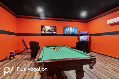 a gaming room with a pool table and televisions at 7617 Brookhurst lane in Orlando