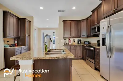 a kitchen with wooden cabinets and a stainless steel refrigerator at 7617 Brookhurst lane in Orlando