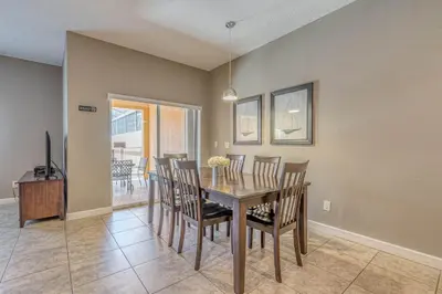a dining room with a table and chairs at Resort Retreat in Kissimmee
