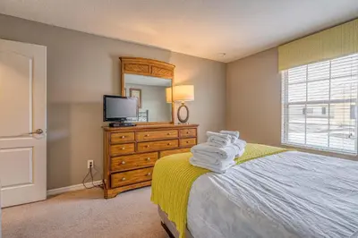 a bedroom with a bed with a television and a dresser at Resort Retreat in Kissimmee