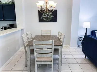 a dining room table with chairs and a chandelier at Crystal Villa in Kissimmee