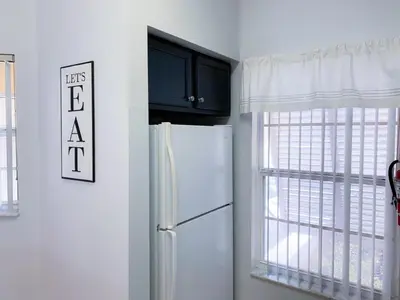 a kitchen with a refrigerator and a window at Crystal Villa in Kissimmee