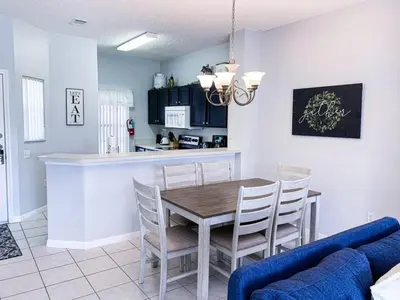 a kitchen and dining room with a table and chairs at Crystal Villa in Kissimmee