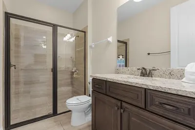 a bathroom with a shower and a toilet and a sink at 520-IBRAHIM · 520 - 8BD Home PoolSpa - MovieGame room in Orlando