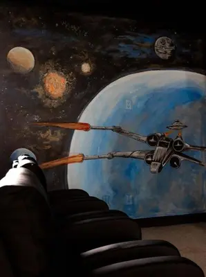 a person is looking at a painting of an astronaut at 520-IBRAHIM · 520 - 8BD Home PoolSpa - MovieGame room in Orlando
