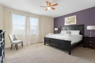 a bedroom with a bed and a ceiling fan at 551 Villa 8BD PoolSpa - Game room Movie room in Orlando