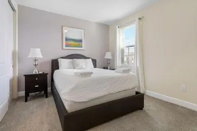 a bedroom with a large bed and a window at 551 Villa 8BD PoolSpa - Game room Movie room in Orlando