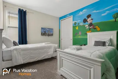 a bedroom with two beds with a mickey mouse mural at 331 Villa SpaPool- GamesTheater by Disney in Orlando