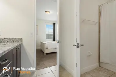 two views of a kitchen and a bathroom with a door at 331 Villa SpaPool- GamesTheater by Disney in Orlando