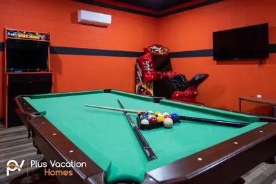 a room with a pool table with balls and bats at 331 Villa SpaPool- GamesTheater by Disney in Orlando