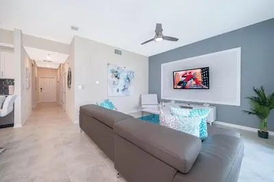 a living room with a couch and a table at 3180-202BV STOREY LAKE, CONDO 2/2 GARDEN VIEW in Kissimmee