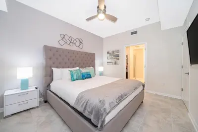 a bedroom with a large bed and a ceiling fan at 3180-202BV STOREY LAKE, CONDO 2/2 GARDEN VIEW in Kissimmee