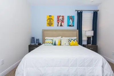 a bedroom with a large white bed with pillows at Gorgeous Single Home with Private Pool at Encore in Orlando