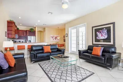 a living room with two leather couches and a table at Mickeys Floridian - Glorious 5BR Private South Facing Pool Hot Tub Game RM GYM BBQ - 2 miles to Disney in Orlando