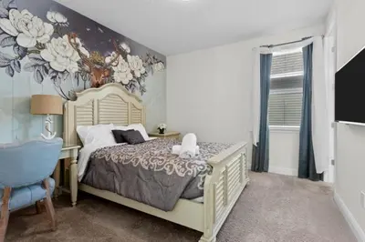 a bedroom with a bed with a flower mural on the wall at 320 Pet Friendly 6BD Villa - PoolSpa in Orlando