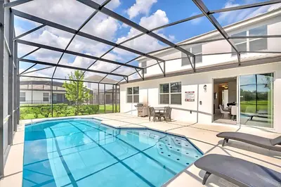 a large swimming pool with a glass ceiling at Family Resort - 6BR Mansion - Private Pool, Home Theater, BBQ and More in Kissimmee