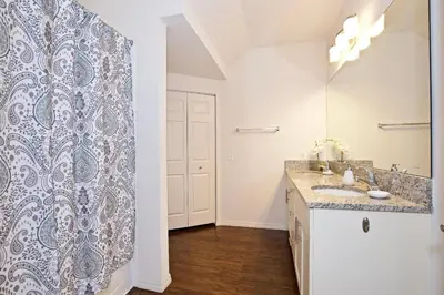 a bathroom with a sink and a mirror at Great and practical townhouse in gated community, sleeps 6 10 min to Disney! in Orlando